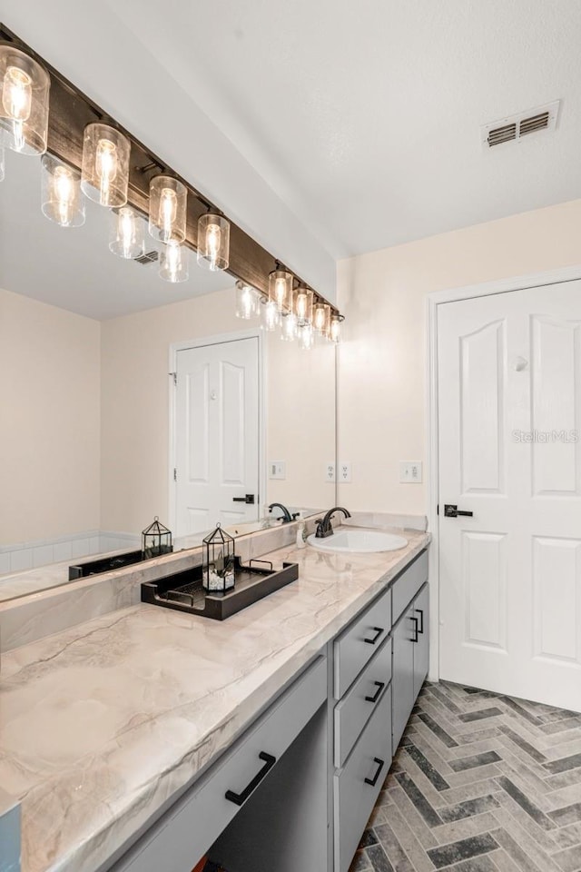 3292 NE 42nd Pl, Ocala, FL 34479 - bathroom with double vanity and brick patterned flooring