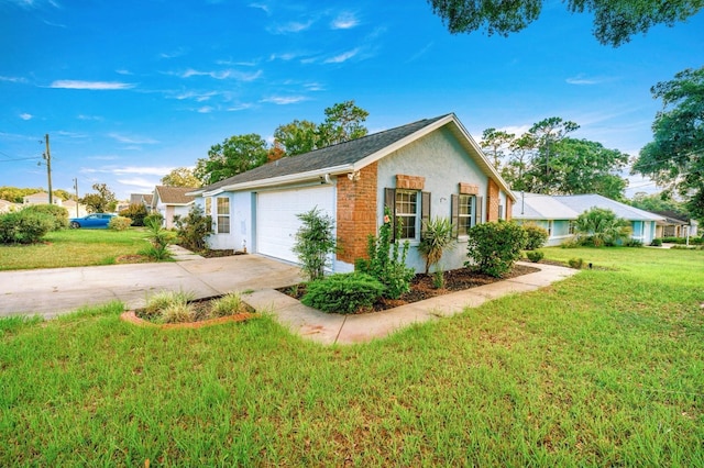 3292 NE 42nd Pl, Ocala, FL 34479 - view of home's exterior featuring concrete driveway, a yard, an attached garage, stucco siding, and brick siding