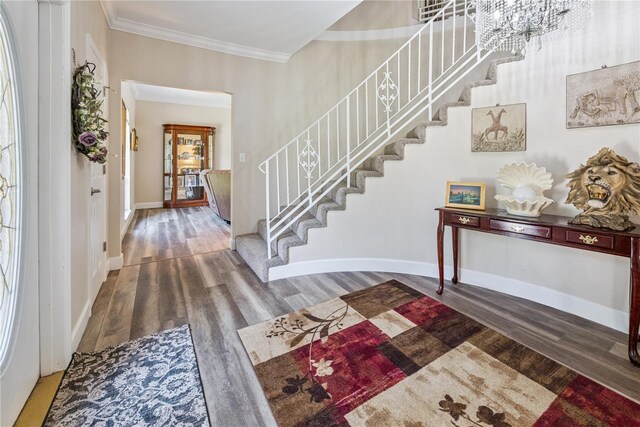 174 SW Dalmation Ln, Lake City, FL 32024 - entryway with stairway, wood finished floors, ornamental molding, and a chandelier