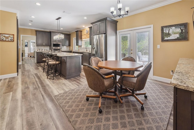174 SW Dalmation Ln, Lake City, FL 32024 - dining room with ornamental molding, wood finished floors, a chandelier, french doors, and recessed lighting