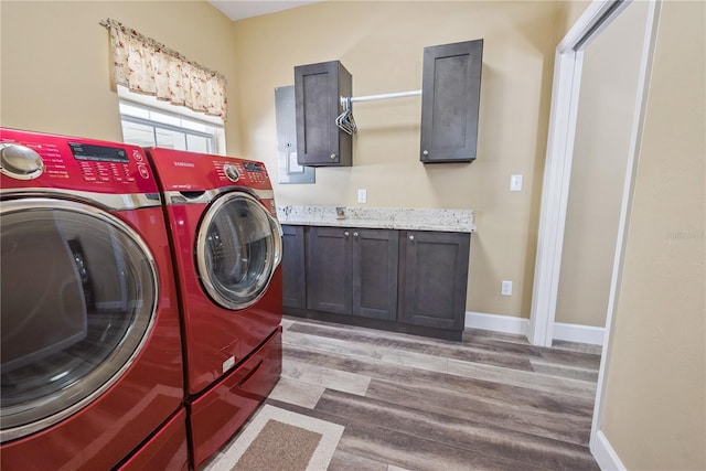 174 SW Dalmation Ln, Lake City, FL 32024 - laundry area with washing machine and clothes dryer, wood finished floors, and cabinet space