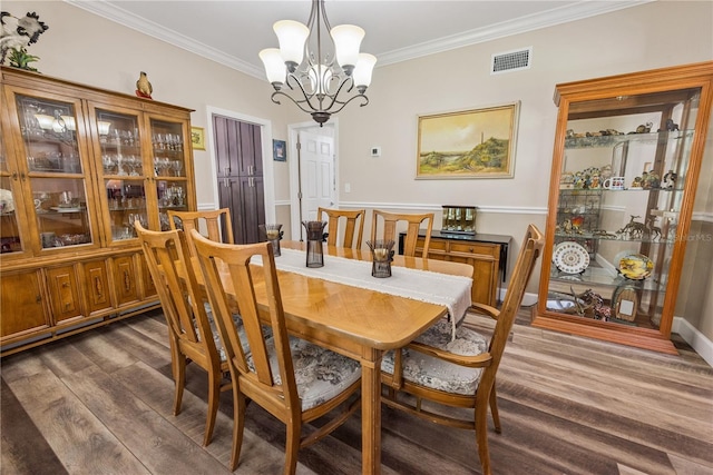 174 SW Dalmation Ln, Lake City, FL 32024 - dining area with dark wood-style flooring, crown molding, and a chandelier