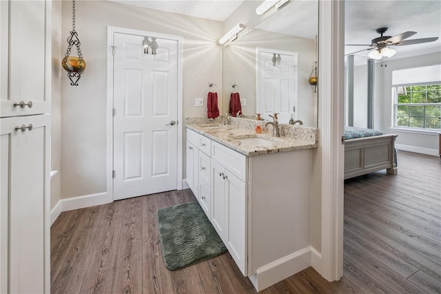 174 SW Dalmation Ln, Lake City, FL 32024 - full bath featuring wood finished floors, double vanity, and ceiling fan