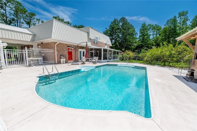 174 SW Dalmation Ln, Lake City, FL 32024 - swimming pool featuring a sunroom and a patio