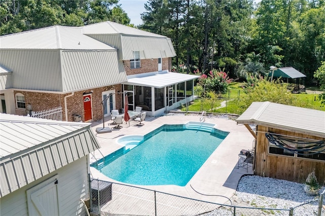 174 SW Dalmation Ln, Lake City, FL 32024 - swimming pool with a sunroom and a patio area
