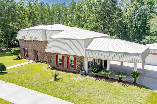 174 SW Dalmation Ln, Lake City, FL 32024 - view of front facade featuring a front yard, brick siding, a metal roof, and concrete driveway