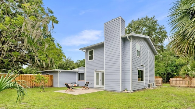 1604 NE 7th St, Gainesville, FL 32609 - back of house with a patio area, a chimney, and french doors