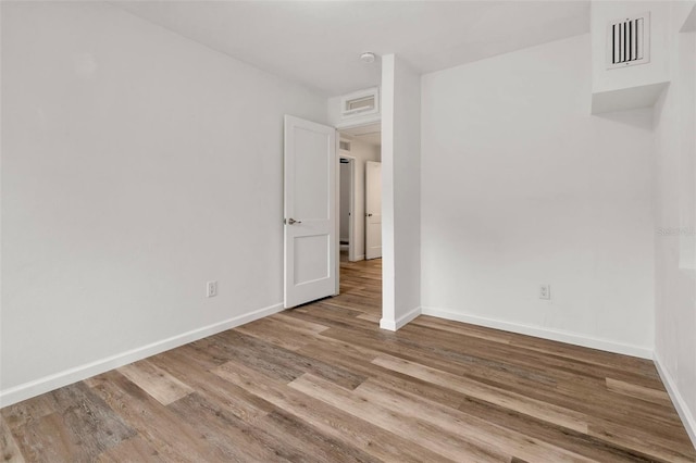 1604 NE 7th St, Gainesville, FL 32609 - spare room with wood finished floors and a smoke detector