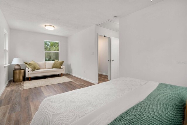 1604 NE 7th St, Gainesville, FL 32609 - bedroom featuring attic access and wood finished floors