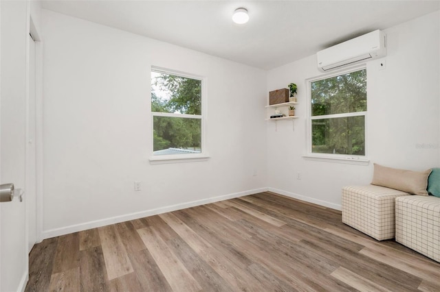 1604 NE 7th St, Gainesville, FL 32609 - unfurnished room featuring a wall mounted AC and wood finished floors