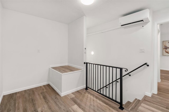 1604 NE 7th St, Gainesville, FL 32609 - stairs featuring an AC wall unit and wood finished floors