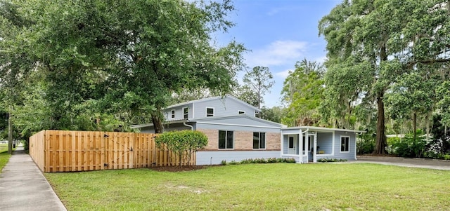 1604 NE 7th St, Gainesville, FL 32609 - view of front of property featuring brick siding, a gate, and view of scattered trees