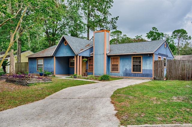 2510 NW 50th Pl, Gainesville, FL 32605 - view of front of home featuring a chimney, a shingled roof, and driveway