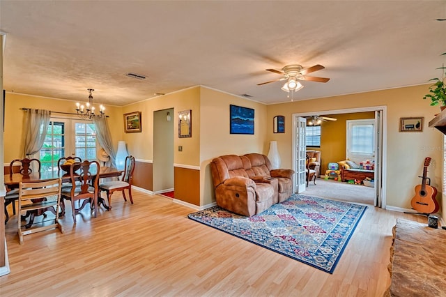 2510 NW 50th Pl, Gainesville, FL 32605 - living room featuring light wood finished floors, a chandelier, and ceiling fan