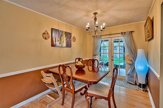 2510 NW 50th Pl, Gainesville, FL 32605 - dining room with a chandelier, french doors, wood finished floors, and crown molding