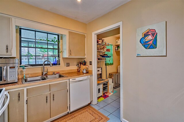 2510 NW 50th Pl, Gainesville, FL 32605 - kitchen featuring dishwasher, stainless steel microwave, light countertops, range, and light tile patterned floors