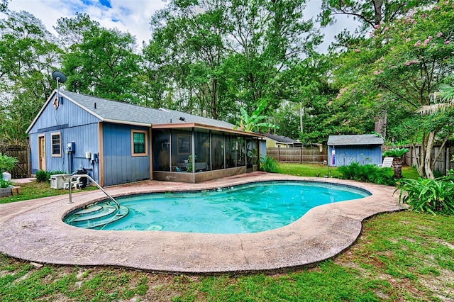 2510 NW 50th Pl, Gainesville, FL 32605 - view of swimming pool with a sunroom, a fenced backyard, view of scattered trees, and a shed