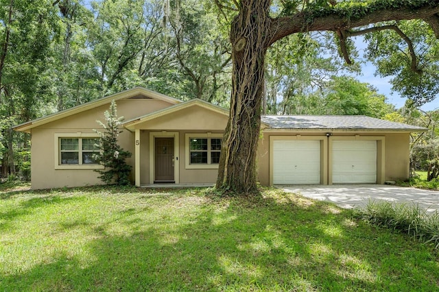 5 NW 28th Ter, Gainesville, FL 32607 - view of front facade with stucco siding, driveway, and a front yard
