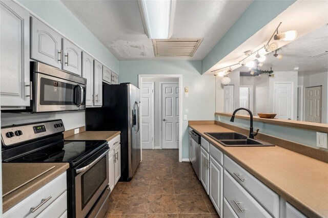 5 NW 28th Ter, Gainesville, FL 32607 - kitchen featuring appliances with stainless steel finishes, stone finish floors, and light countertops