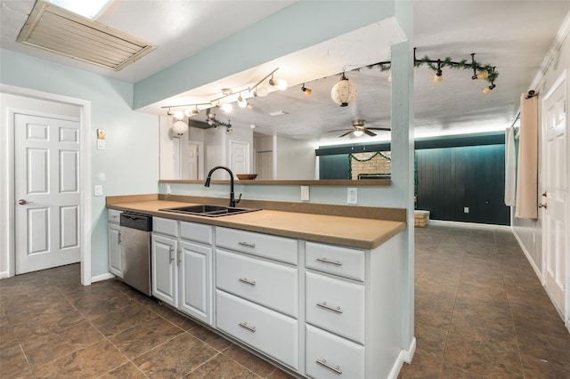 5 NW 28th Ter, Gainesville, FL 32607 - kitchen with stainless steel dishwasher, white cabinetry, a ceiling fan, and dark stone finish floors