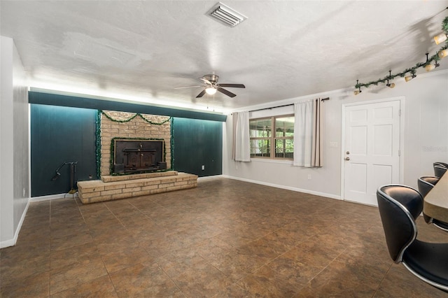 5 NW 28th Ter, Gainesville, FL 32607 - unfurnished living room featuring ceiling fan and a brick fireplace