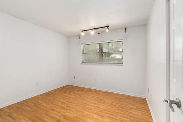 5 NW 28th Ter, Gainesville, FL 32607 - empty room with light wood-style floors and rail lighting