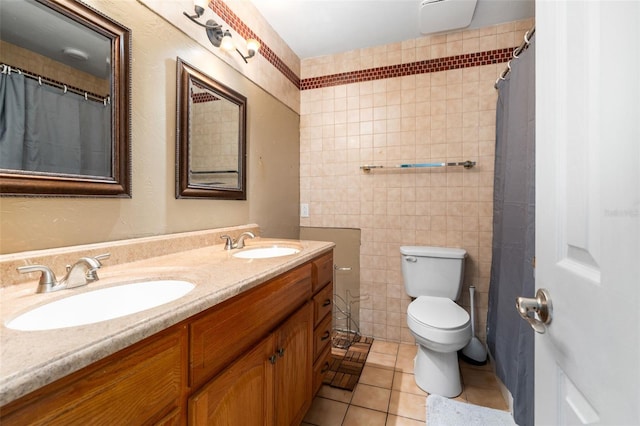 5 NW 28th Ter, Gainesville, FL 32607 - full bath with tile walls, double vanity, and tile patterned flooring