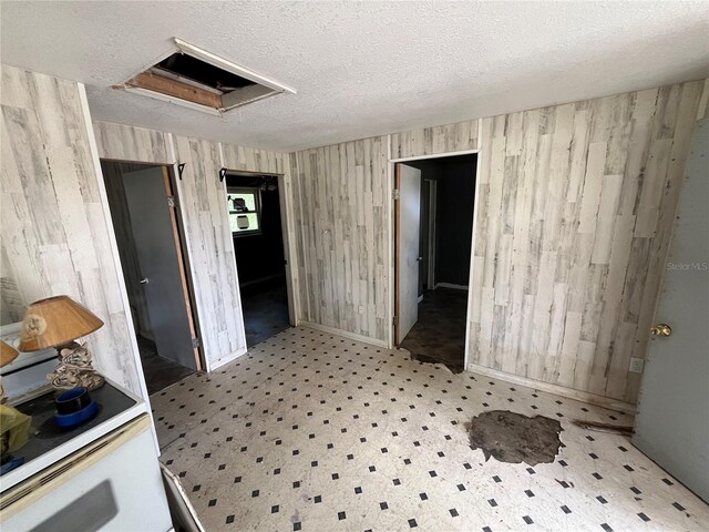 654 NE 2nd St, Crystal River, FL 34429 - spare room with a textured ceiling and wood walls