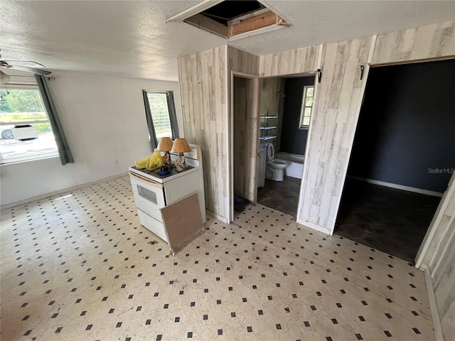 654 NE 2nd St, Crystal River, FL 34429 - dining area featuring wood walls, a textured ceiling, and a ceiling fan