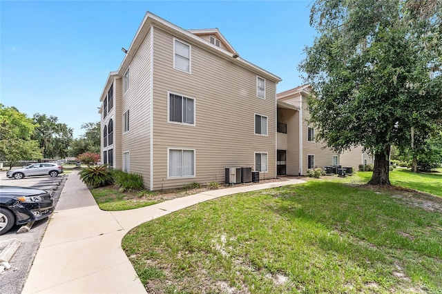 3800 SW 20th Ave Unit 210, Gainesville, FL 32607 - view of side of home with a yard and a cooling unit