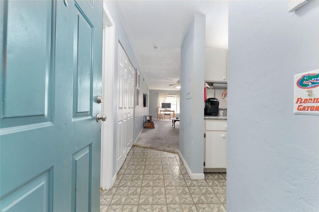 3800 SW 20th Ave Unit 210, Gainesville, FL 32607 - hallway featuring light floors and baseboards
