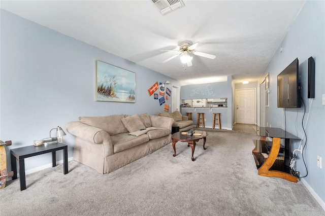 3800 SW 20th Ave Unit 210, Gainesville, FL 32607 - carpeted living area featuring ceiling fan and baseboards
