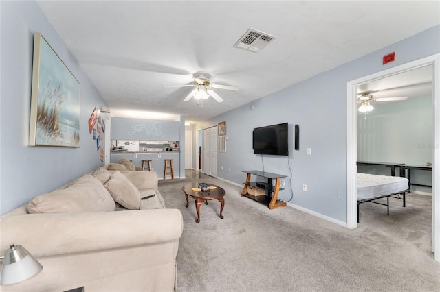 3800 SW 20th Ave Unit 210, Gainesville, FL 32607 - carpeted living area with ceiling fan and baseboards