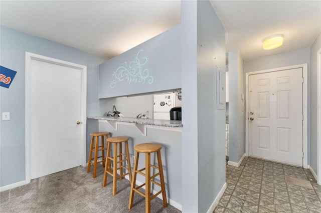3800 SW 20th Ave Unit 210, Gainesville, FL 32607 - kitchen with white fridge, a breakfast bar area, and light countertops