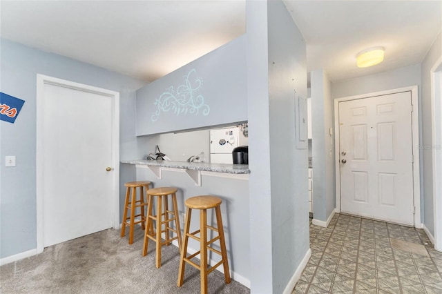 3800 SW 20th Ave Unit 210, Gainesville, FL 32607 - kitchen with refrigerator, a breakfast bar area, and light countertops