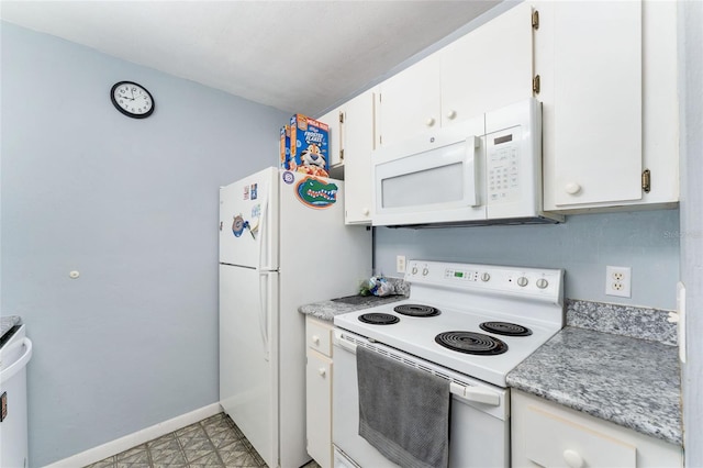 3800 SW 20th Ave Unit 210, Gainesville, FL 32607 - kitchen featuring white appliances, light countertops, and white cabinetry
