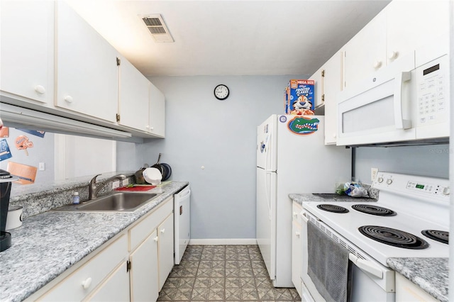 3800 SW 20th Ave Unit 210, Gainesville, FL 32607 - kitchen with white appliances, light countertops, white cabinets, and light floors
