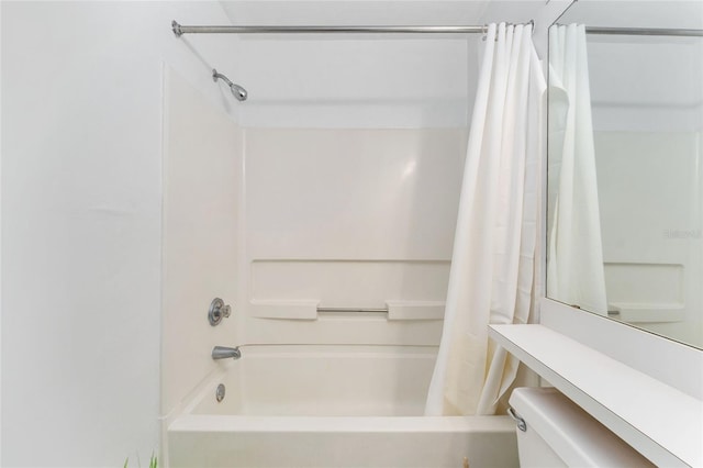 3800 SW 20th Ave Unit 210, Gainesville, FL 32607 - bathroom featuring shower / bath combo with shower curtain and toilet