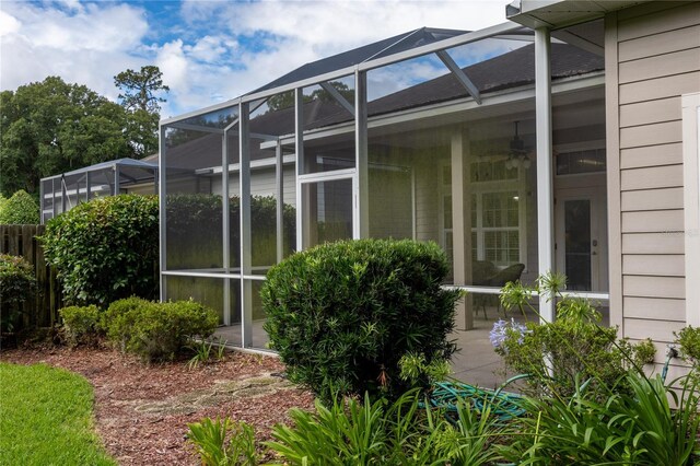 3737 SW 74th Dr, Gainesville, FL 32608 - view of side of home featuring ceiling fan and glass enclosure