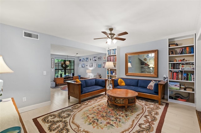 900 SW 62nd Blvd Unit H43, Gainesville, FL 32607 - living room featuring wood finished floors, ceiling fan, and built in shelves