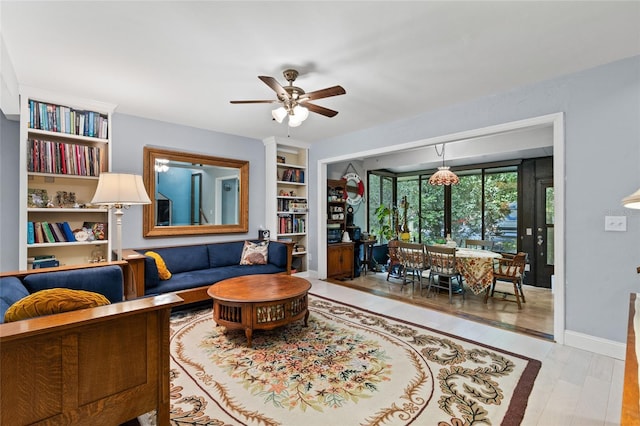 900 SW 62nd Blvd Unit H43, Gainesville, FL 32607 - living area with ceiling fan, wood finished floors, and built in shelves