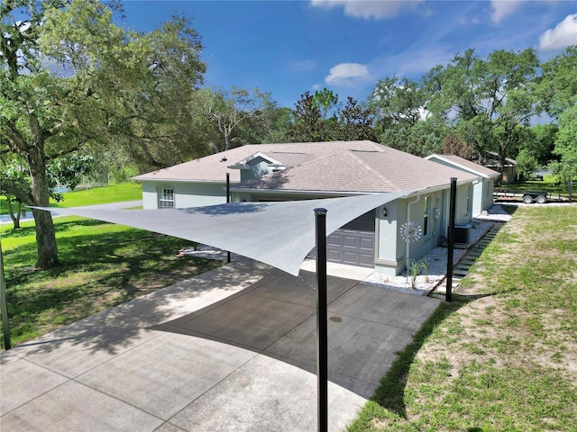 8198 N Brook Way, Citrus Springs, FL 34433 - view of property exterior featuring stucco siding, a lawn, a garage, concrete driveway, and view of scattered trees