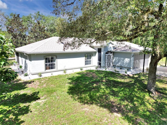 8198 N Brook Way, Citrus Springs, FL 34433 - view of front of house featuring an attached garage, stucco siding, a front lawn, and roof with shingles