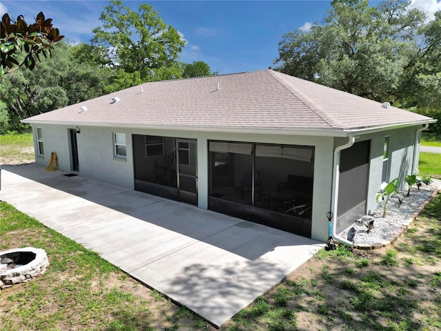 8198 N Brook Way, Citrus Springs, FL 34433 - back of house featuring a patio, an outdoor fire pit, stucco siding, a sunroom, and a shingled roof