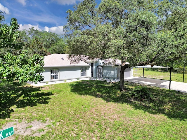 8198 N Brook Way, Citrus Springs, FL 34433 - view of front facade featuring driveway, a front lawn, and stucco siding