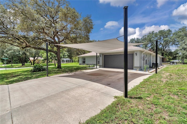 8198 N Brook Way, Citrus Springs, FL 34433 - view of property exterior featuring an attached garage, a yard, concrete driveway, and stucco siding