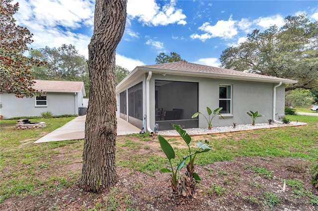 8198 N Brook Way, Citrus Springs, FL 34433 - rear view of property with a sunroom, a yard, and stucco siding