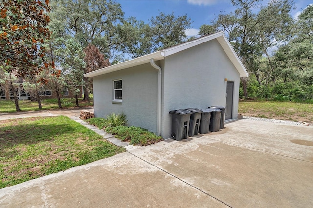 8198 N Brook Way, Citrus Springs, FL 34433 - view of side of property with stucco siding, a lawn, and a patio area
