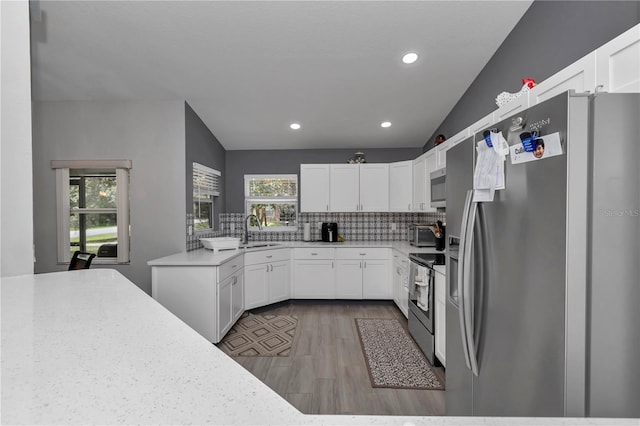 8198 N Brook Way, Citrus Springs, FL 34433 - kitchen featuring stainless steel appliances, backsplash, wood finished floors, white cabinetry, and recessed lighting