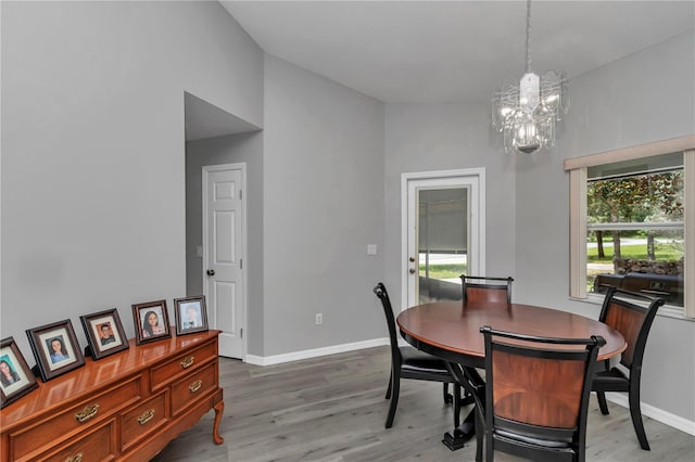 8198 N Brook Way, Citrus Springs, FL 34433 - dining space featuring a chandelier, healthy amount of natural light, and light wood-style flooring